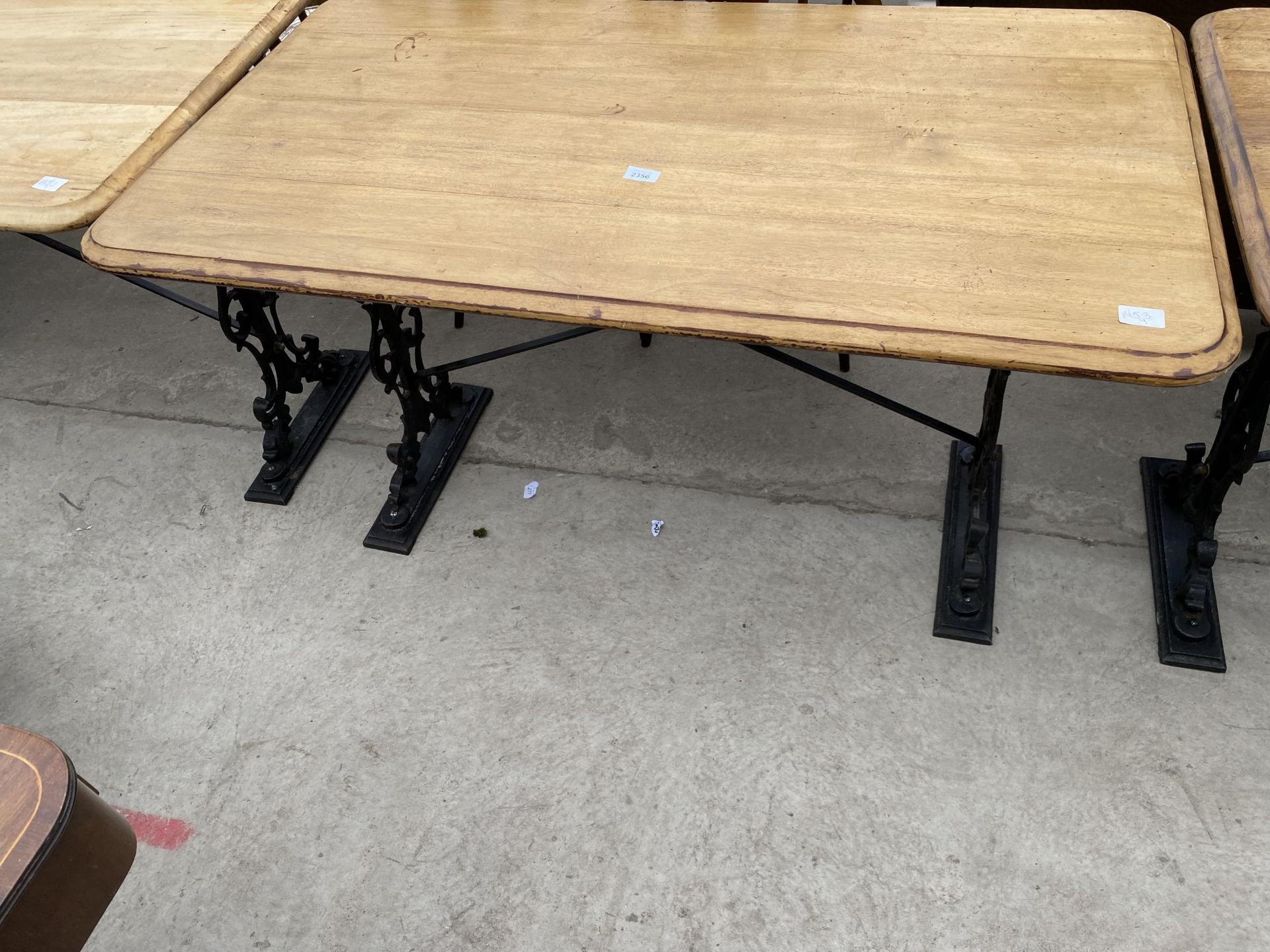 A PUB TABLE ON CAST IRON BASE, 48X27"