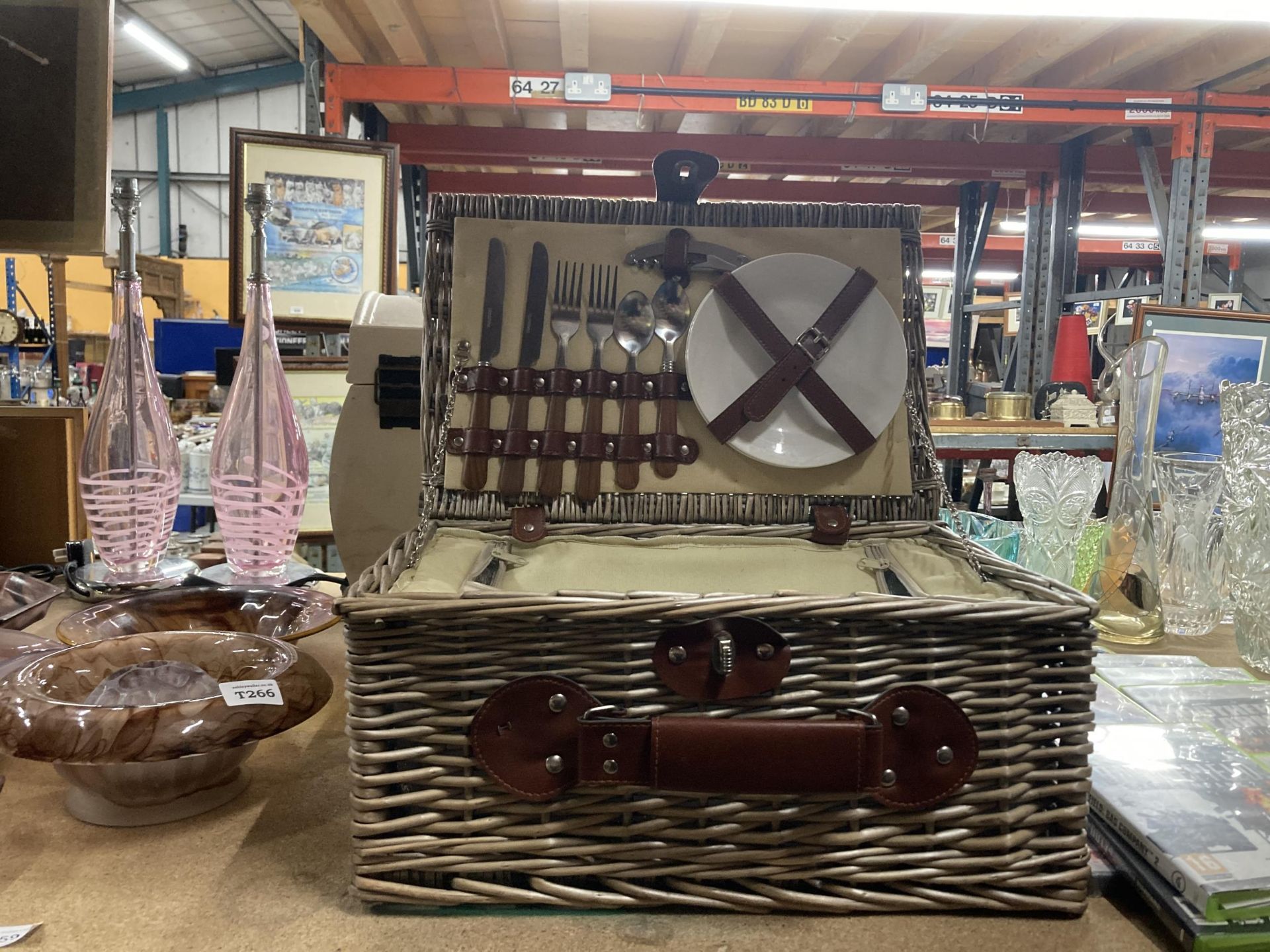 A WICKER PICNIC BASKET WITH ACCESSORIES