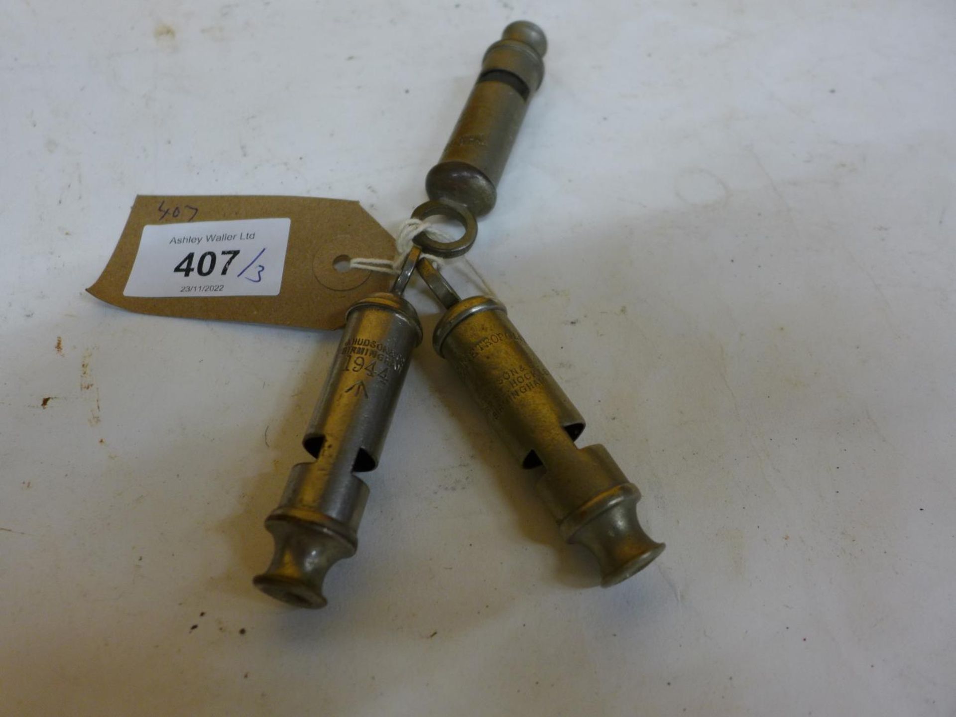 A J. HUDSON MILITARY WHISTLE DATED 1944 AND TWO METROPOLITON WHISTLES (3)