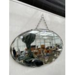 AN ART DECO BEVELED EDGE UNFRAMED MIRROR WITH HANGING CHAIN