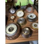 A LARGE AMOUNT OF WOODEN AND BRASS BAROMETERS PLUS AN ALARM CLOCK IN THE GUISE OF A POCKET WATCH