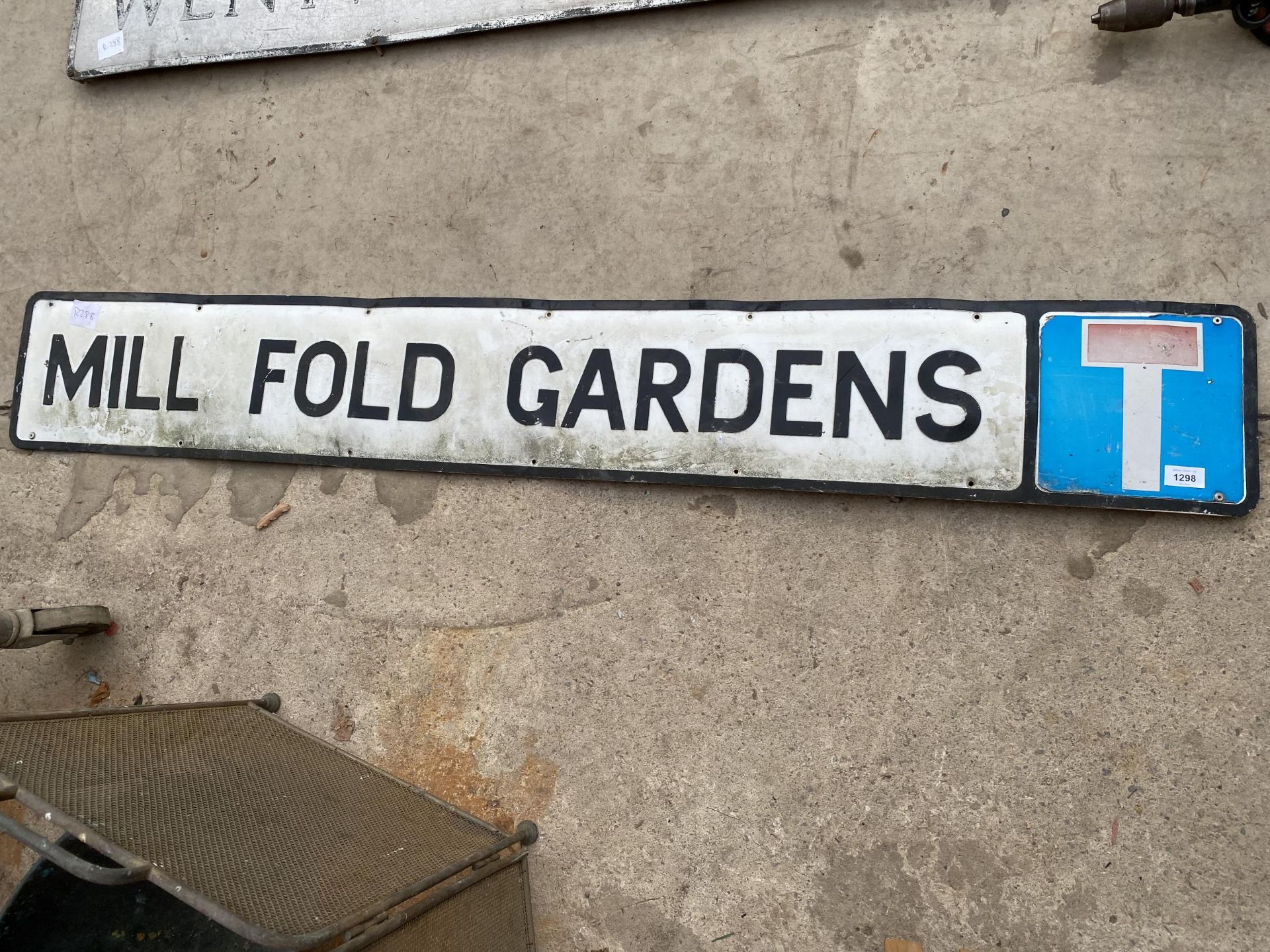 A VINTAGE METAL 'MILL FOLD GARDNES' ROAD SIGN