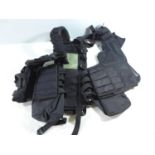 A BLACK TACTICAL LOAD BEARING VEST, WITH NUMEROUS POUCHES