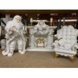 A CHRISTMAS DECORATION OF FATHER CHRISTMAS, A FIRE WITH STOCKINGS AND A CHAIR WITH A DOG