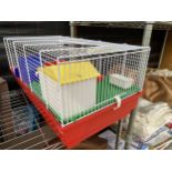 A HAMSTER CAGE WITH AN ASSORTMENT OF ACCESSORIES