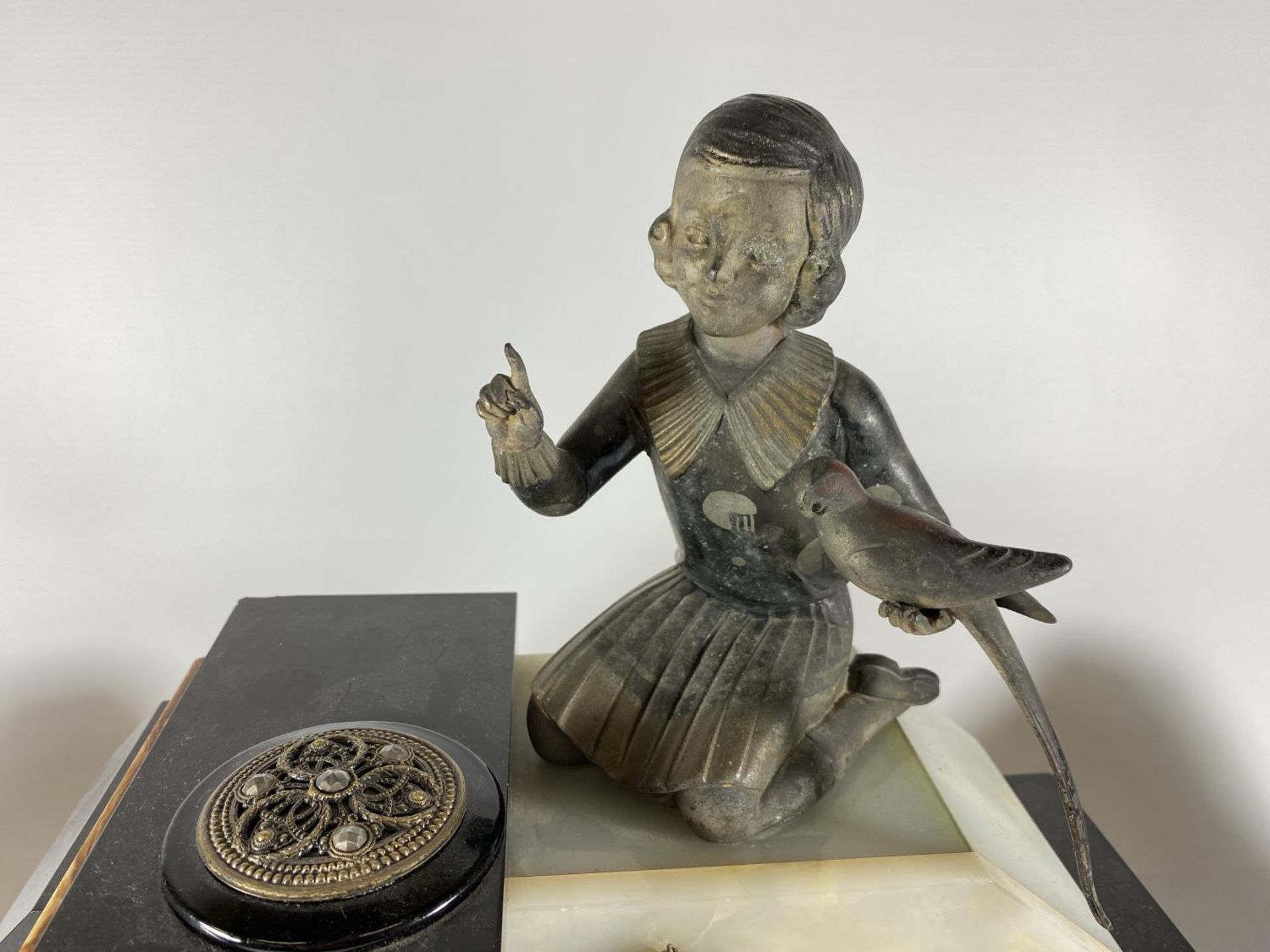 AN ART DECO MANTLE CLOCK WITH GIRL WITH BIRD FINIAL DESIGN AND SIDE GARNITURES - Image 2 of 3