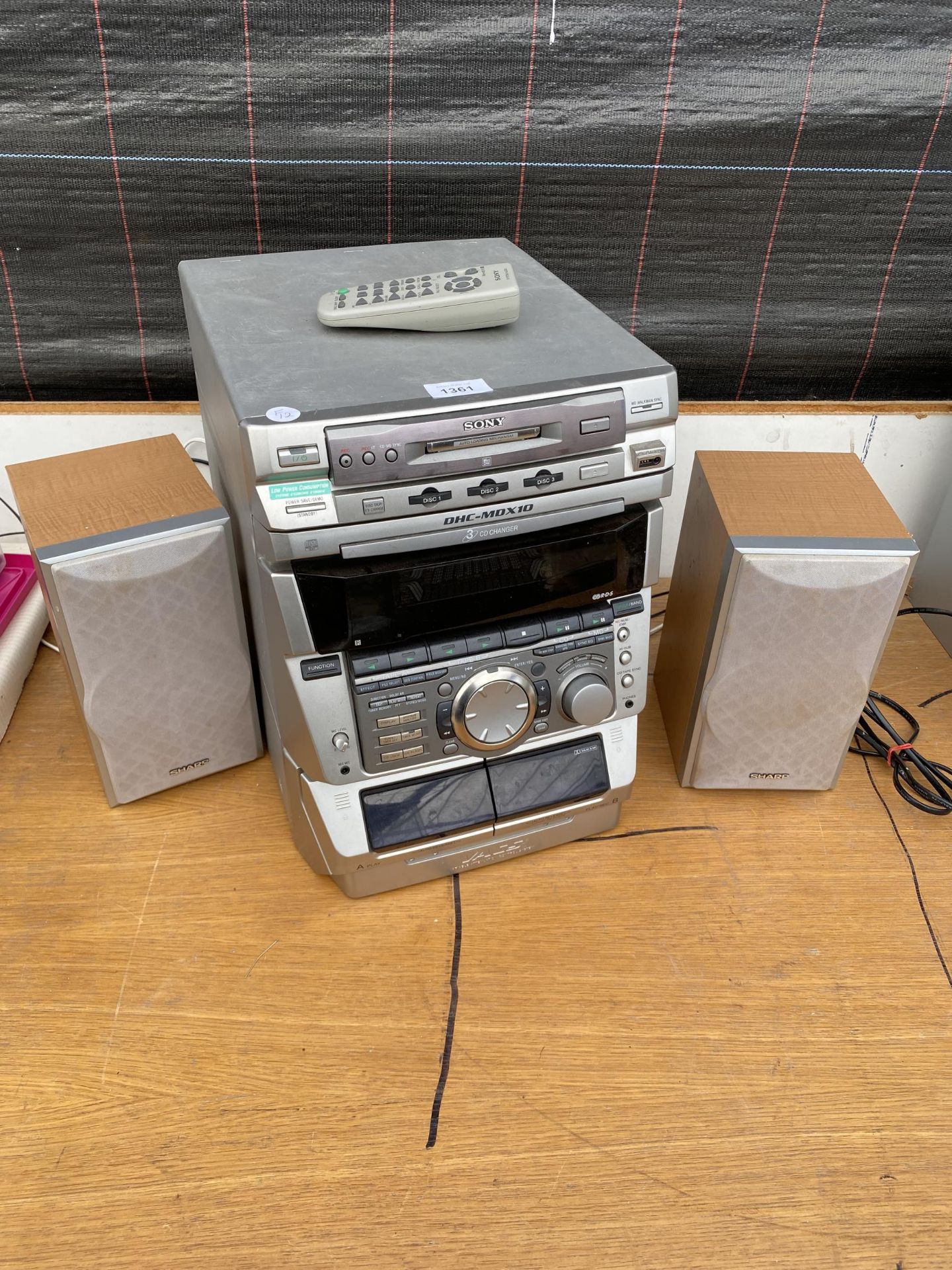 A SONY STEREO SYSTEM WITH 3 CD CHANGER, TAPE DECK AND TWO SHARP SPEAKERS
