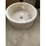 A SOLID CREAM CIRCULAR MARBLE WASH BASIN