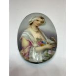 AN OVAL HAND PAINTED GLASS PLAQUE