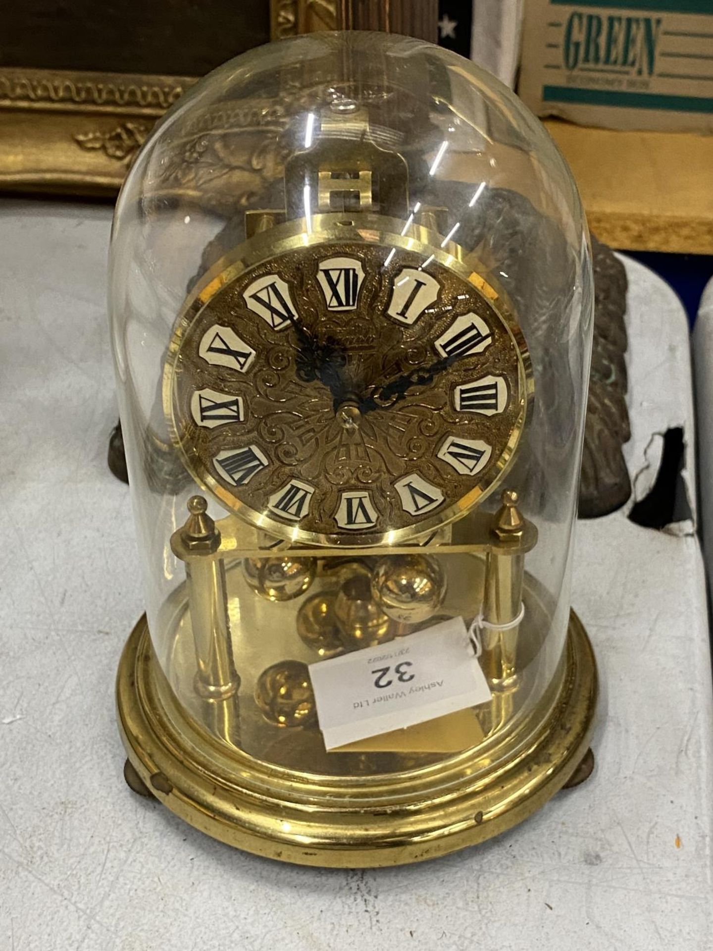 A 1950'S BRASS CASED 'KUNDO' ANNIVERSARY CLOCK WITH GLASS DOME