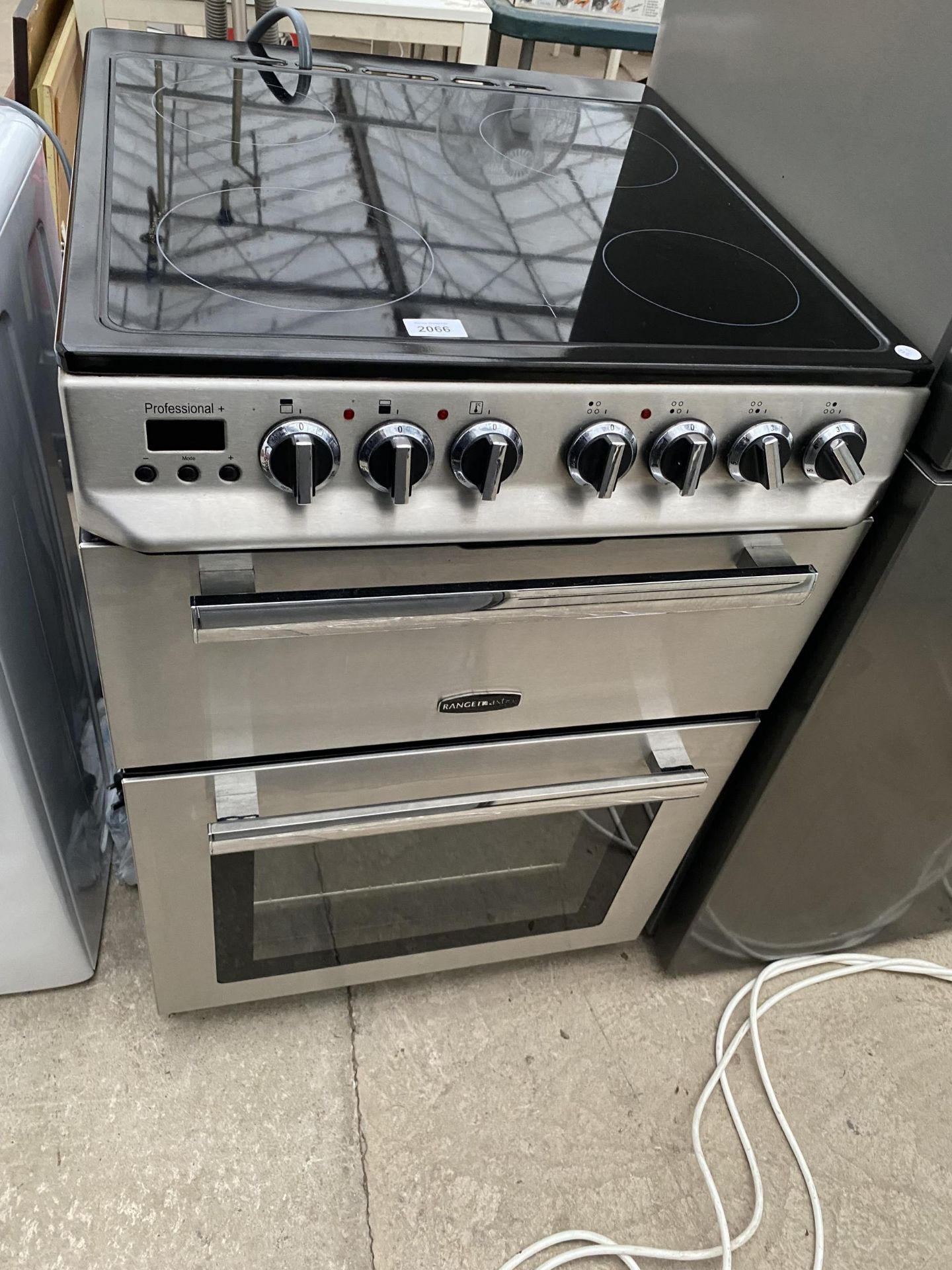A STAINLESS STEEL AND BLACK FREE STANDING RANGEMASTER OVEN AND HOB