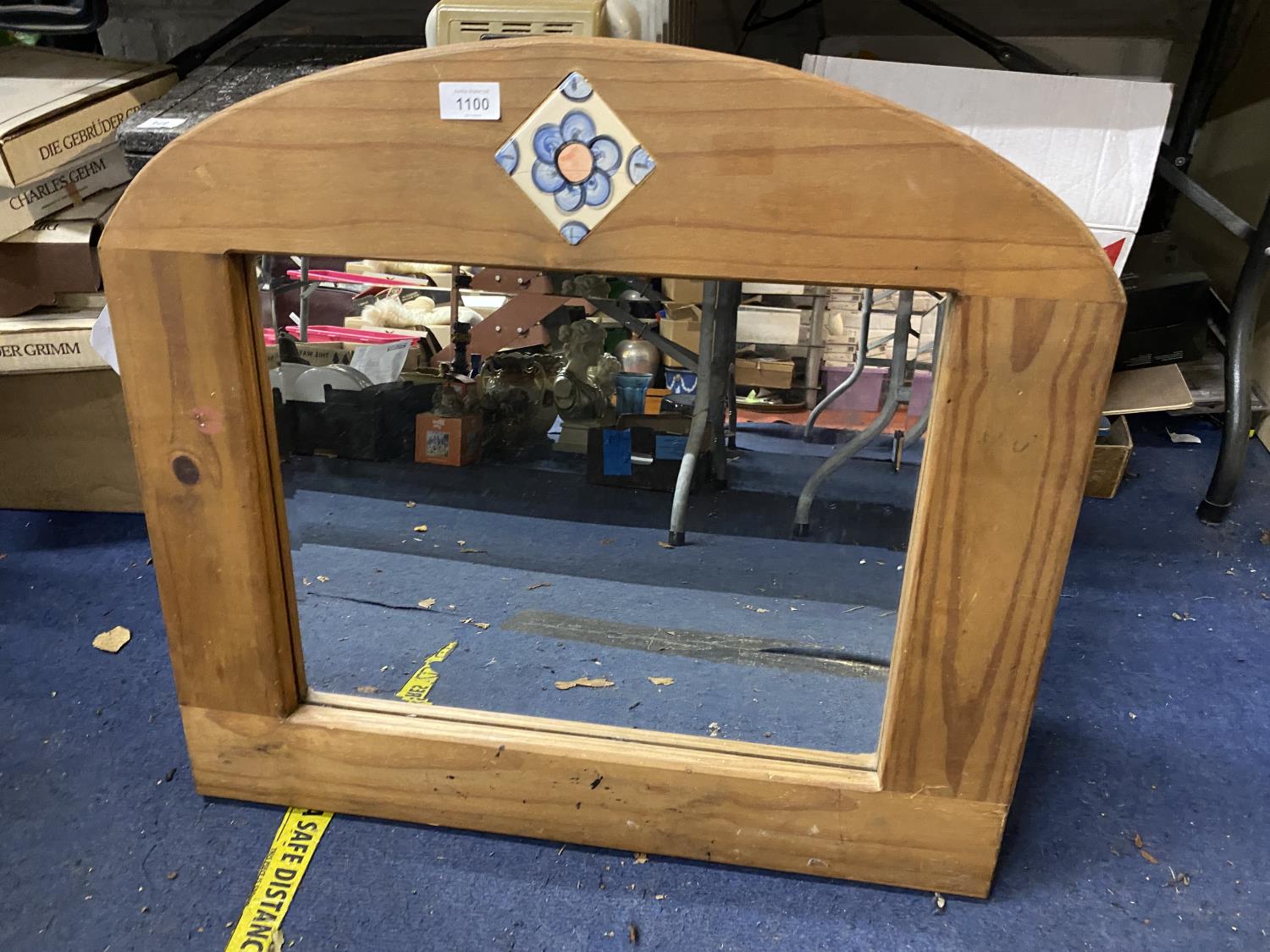 A WOODEN FRAMED MIRROR WITH FLORAL DESIGN