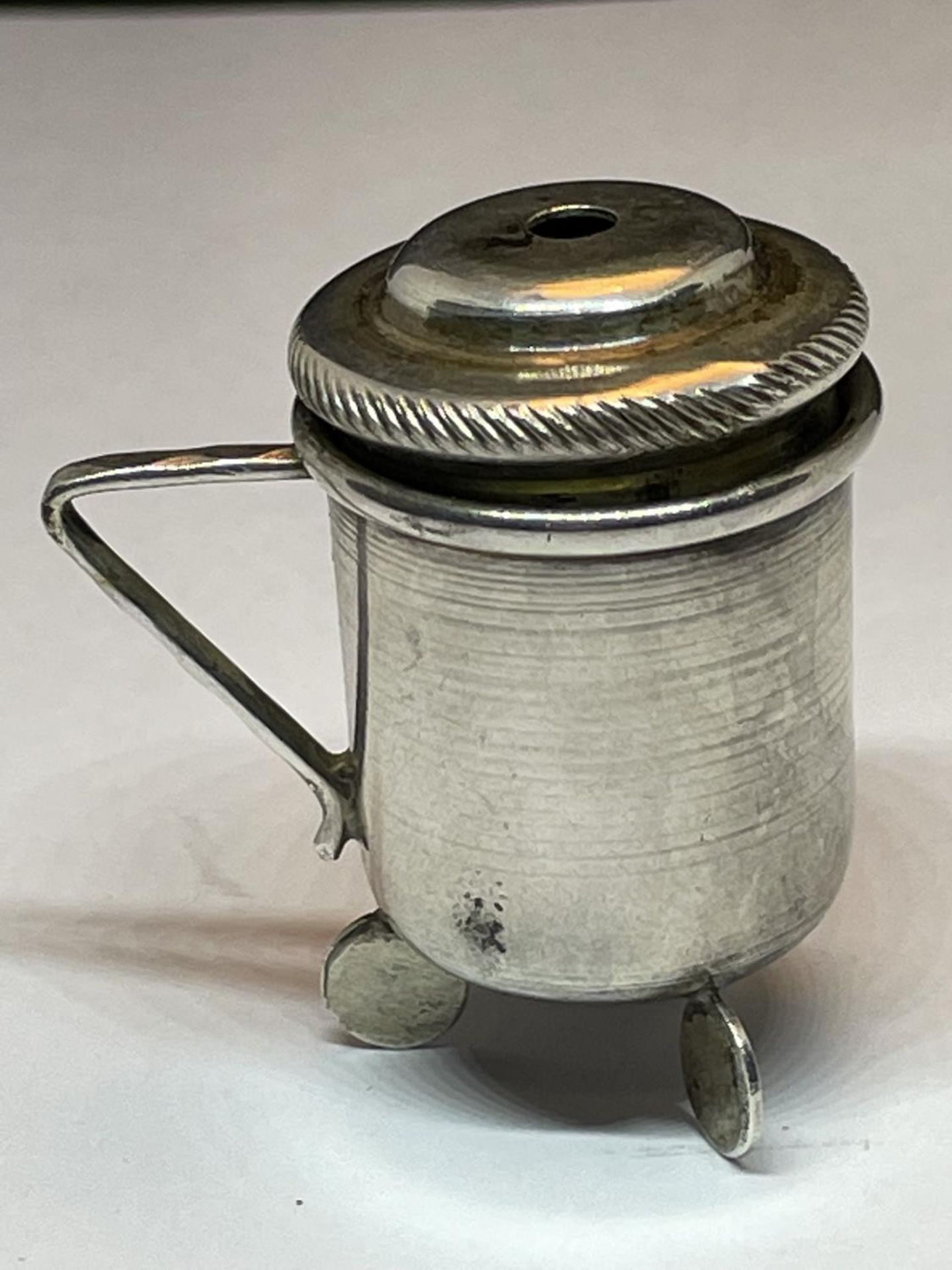 A HALLMARKED LONDON SILVER MINATURE THREE LEGGED HANDLED POT