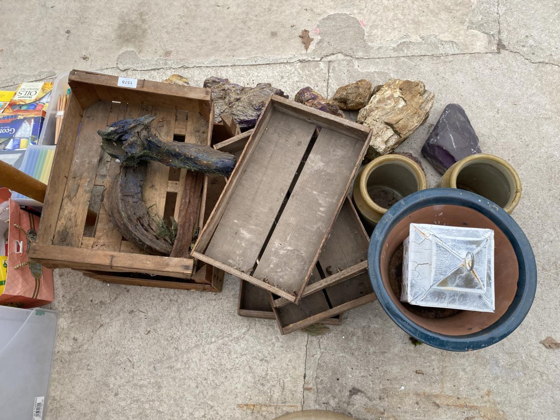 AN ASSORTMENT OF DECORATIVE ROCKS AND WOODEN CRATES ETC