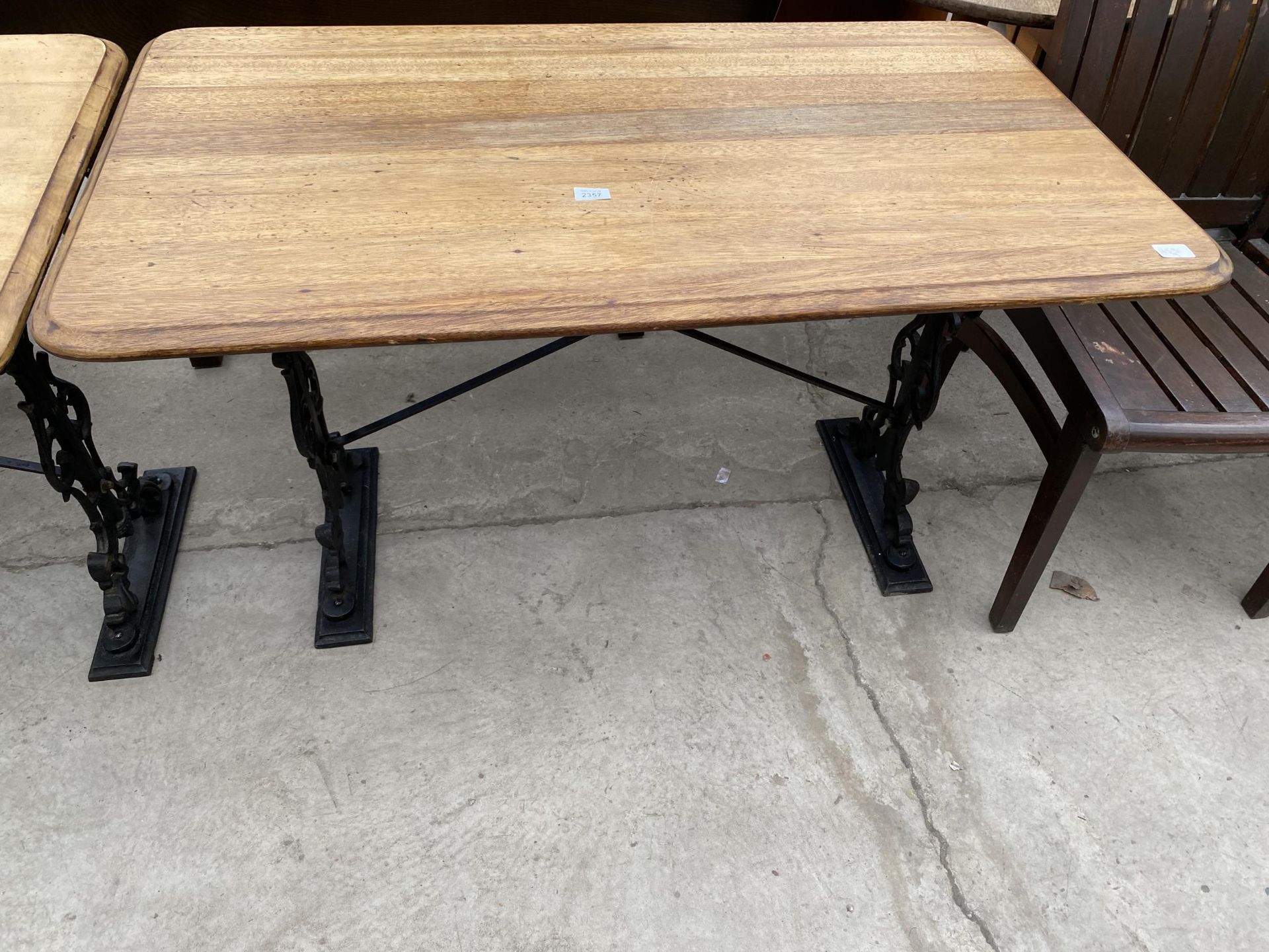 A PUB TABLE ON CAST IRON BASE, 48X27"