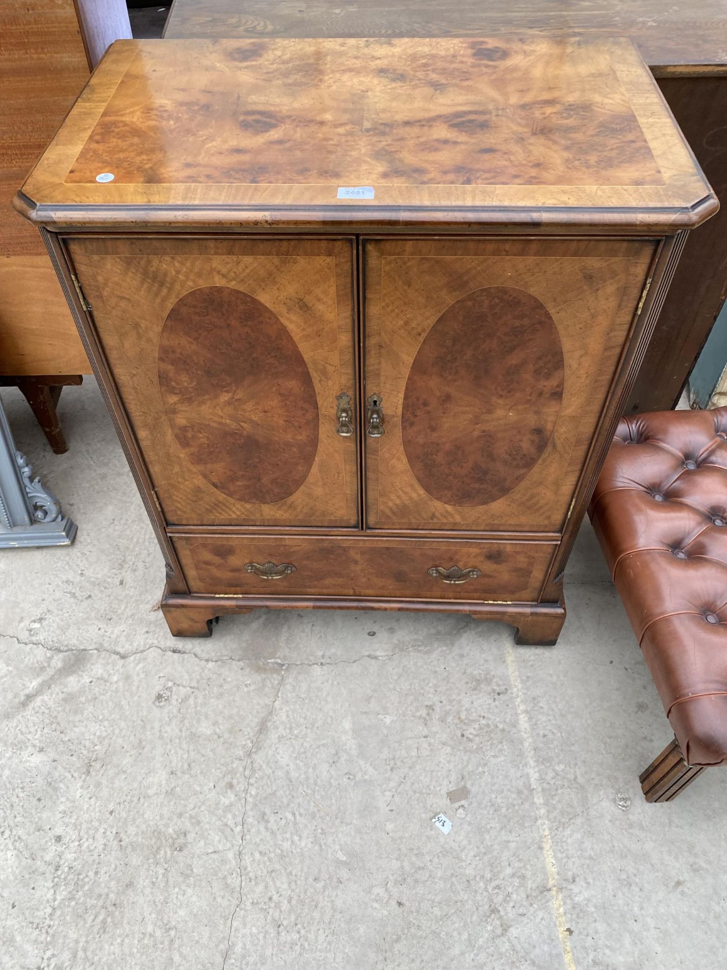 AN 'ANTOBEE' WALNUT AND CROSSBANDED TV CABINET