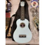 A CHILD'S BLUE UKELELE IN A CASE