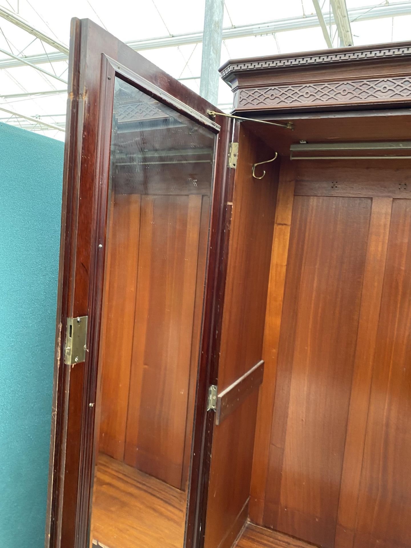 AN EDWARDIAN MAHOGANY 'CHIPPENDALE' STYLE TRIPLE WARDROBE ENCLOSING HANGING COMPARTMENTS, FIVE - Image 14 of 14