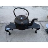 A VINTAGE CAST IRON KETTLE AND TRIVET STAND