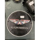 A CAST ASTON MARTIN SIGN DIAMETER 24CM