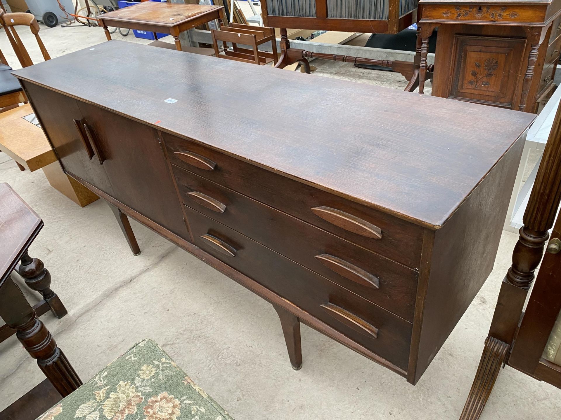 A TEAK 'JENTIQUE' SIDEBOARD, 66" WIDE, ENCLOSING THREE DRAWERS AND TWO CUPBOARDS