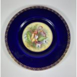 A ROYAL WORCESTER HAND PAINTED PORCELAIN PLATE, SIGNED J.PRICE DEPECITING FLOWERS AGAINST A COBALT