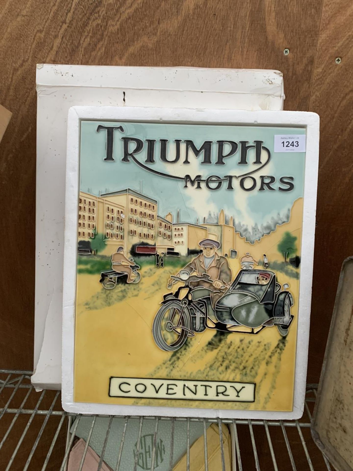 A 'TRIUMPH MOTORS' CERAMIC WALL TILE (A/F)