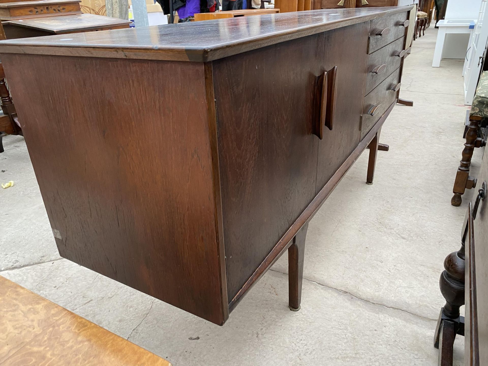 A TEAK 'JENTIQUE' SIDEBOARD, 66" WIDE, ENCLOSING THREE DRAWERS AND TWO CUPBOARDS - Image 4 of 5