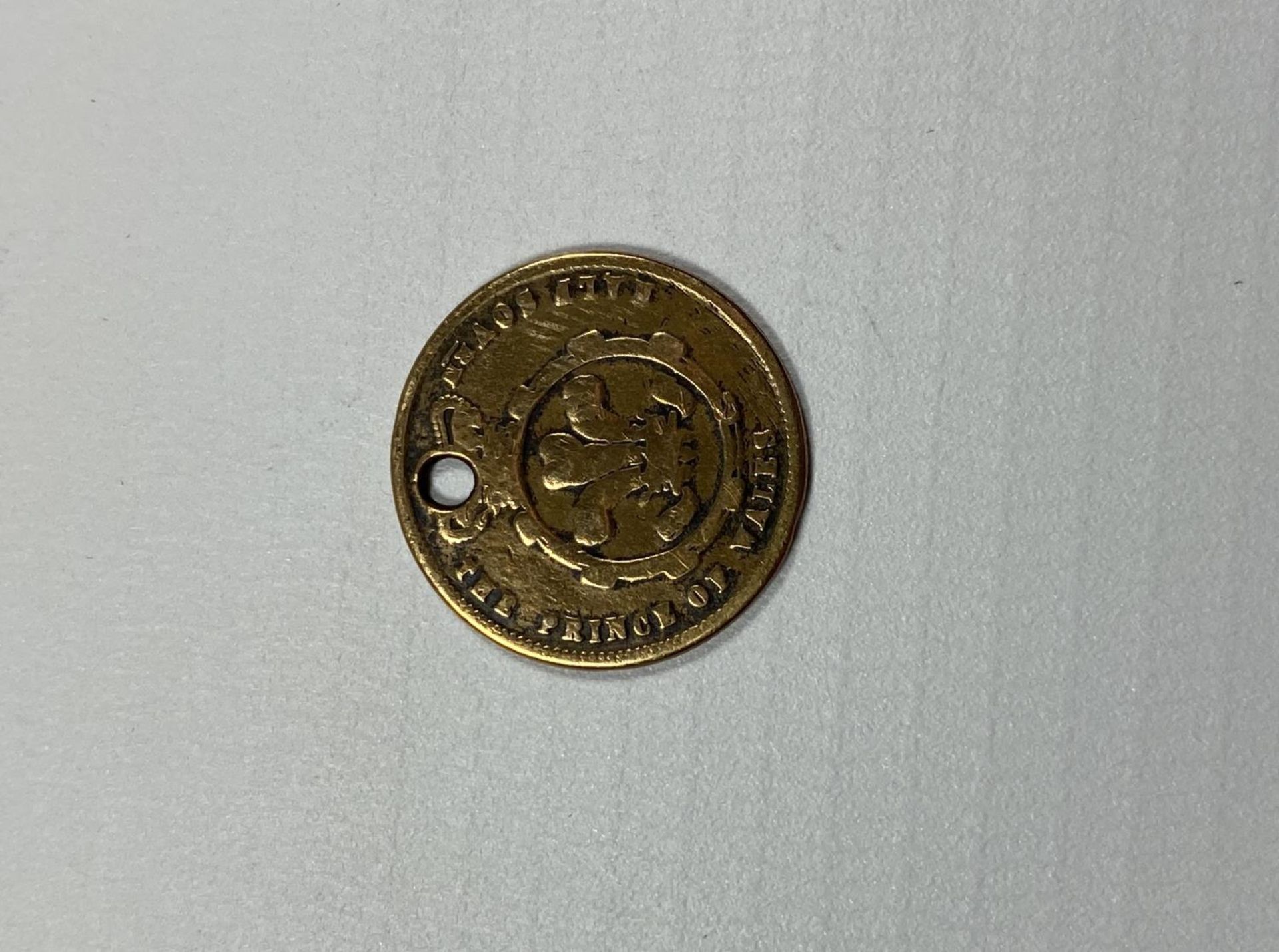 A YELLOW METAL COIN