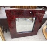 A MODERN RED LAQUERED WALL MIRROR, 24" SQUARE