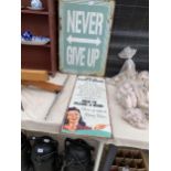 A TIN 'NEVER GIVE UP SIGN' AND A FURTHER TIN 'HOW TO PLEASE A WOMAN SIGN'
