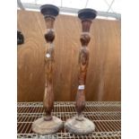 A PAIR OF CARVED WOODEN CANDLESTICKS WITH INSET FLORAL DESIGN