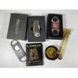A MIXED LOT OF CIGAR ACCESSORIES TO INCLUDE BOXED LIGHTER, GOLD PLATED CIGAR CUTTER ETC