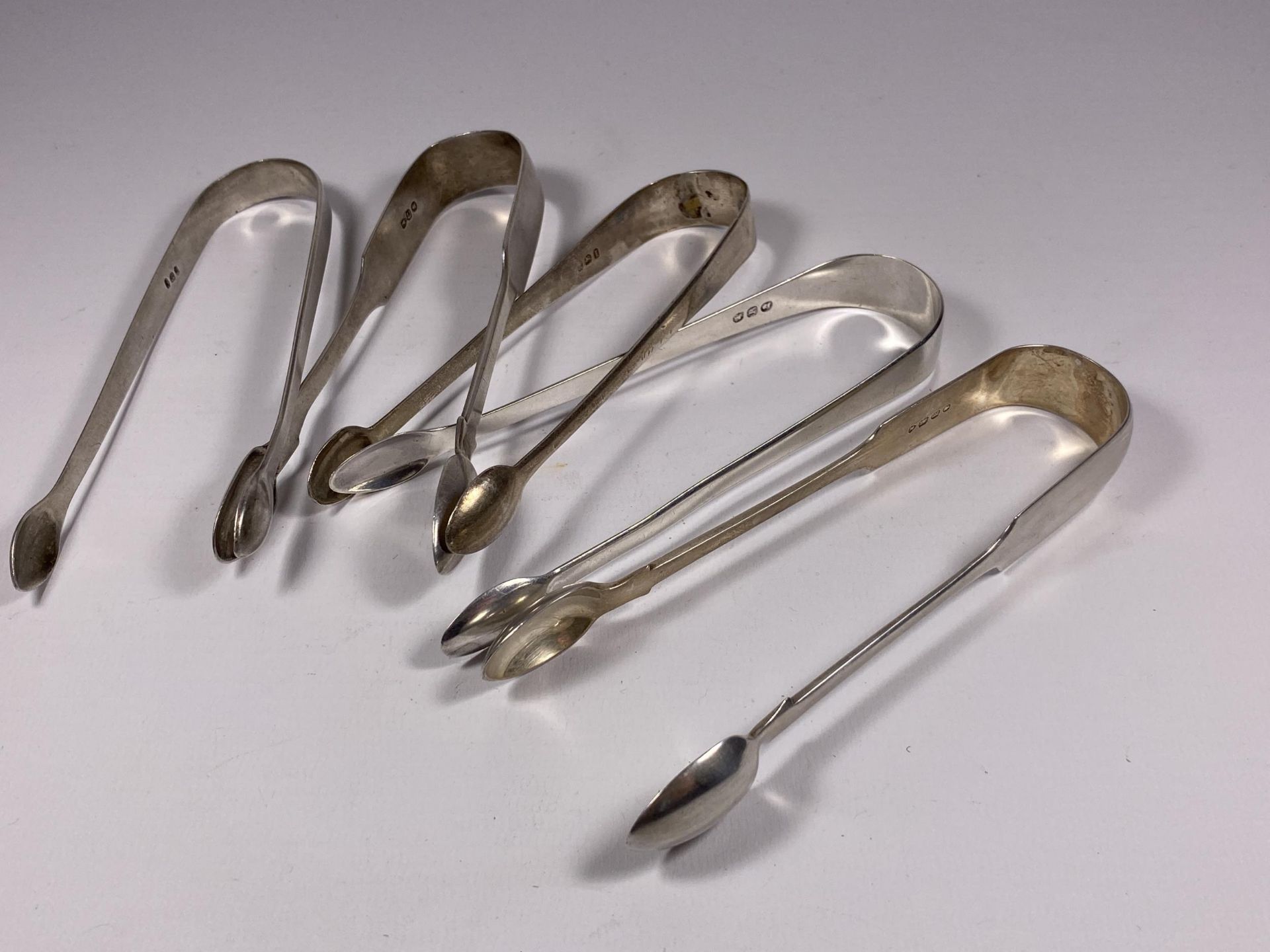 FIVE ASSORTED HALLMARKED SILVER SUGAR TONGS