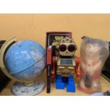 FOUR ITEMS - A BOXED ELECTRONIC SPACE MONSTER, PLASTIC FRED FLINTSTONE MONEY BANK, BOOK & TIN GLOBE