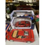 FOUR CARS TO INCLUDE TWO BOXED RADIO CONTROLLED, A BOXED AUDI AND AN UNBOXED BUGATI