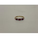 A 9CT YELLOW GOLD RING WITH RED STONES AND CHIP DIAMONDS, SIZE N/O, WEIGHT 1.9G