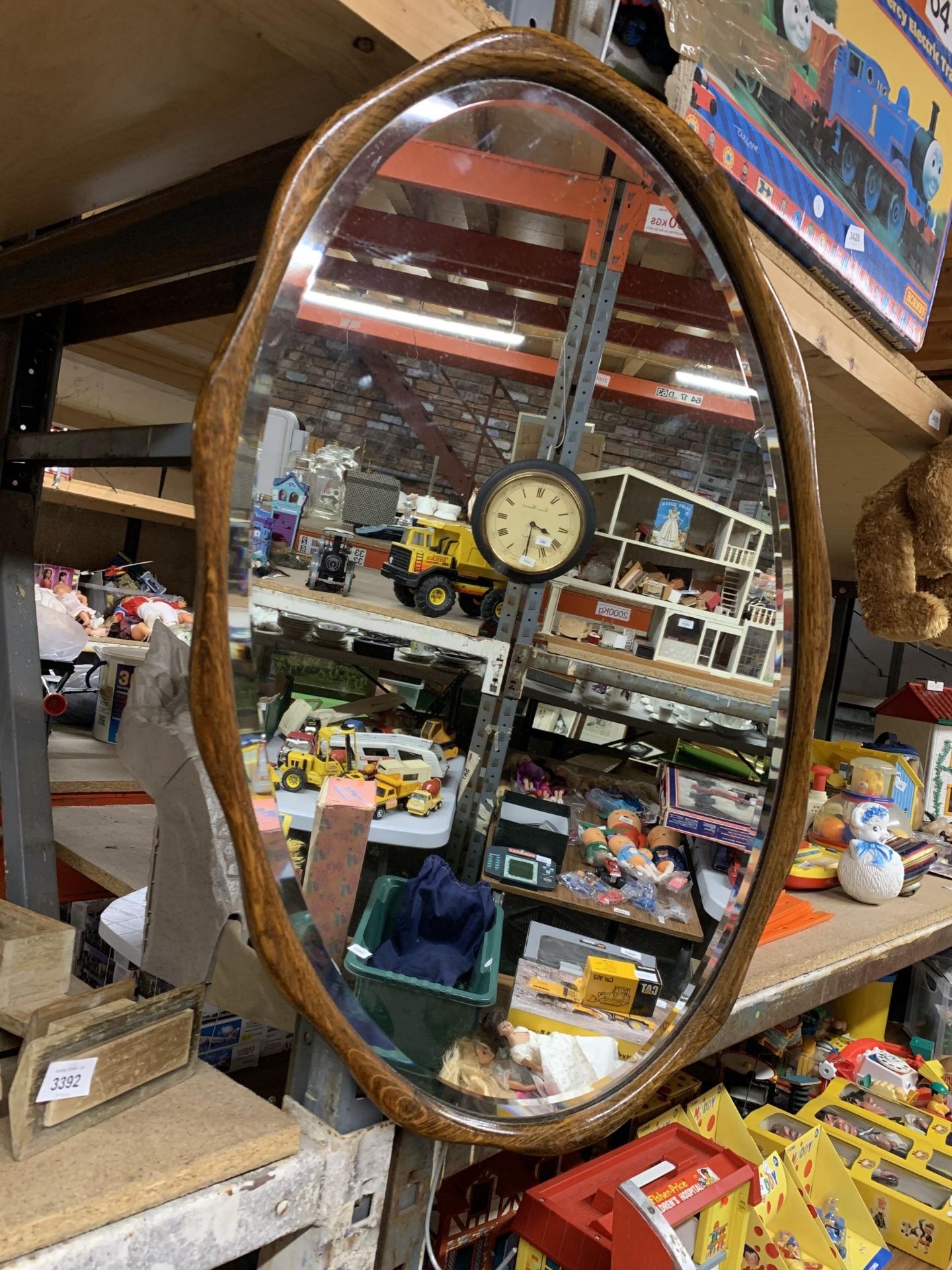 A VINTAGE BEVELLED EDGE MIRROR WITH MAHOGANY FLUTED FRAME