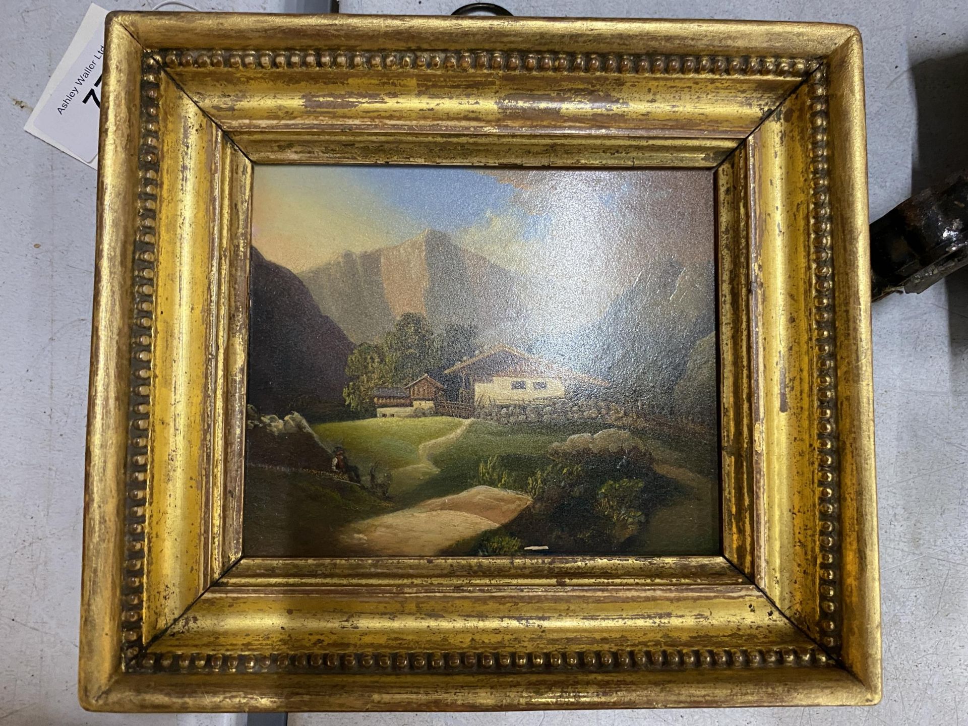 A POSSIBLY SWISS 19TH CENTURY OIL ON PANEL OF A FARM CHALET IN MOUTAINEOUS LANDSCAPE