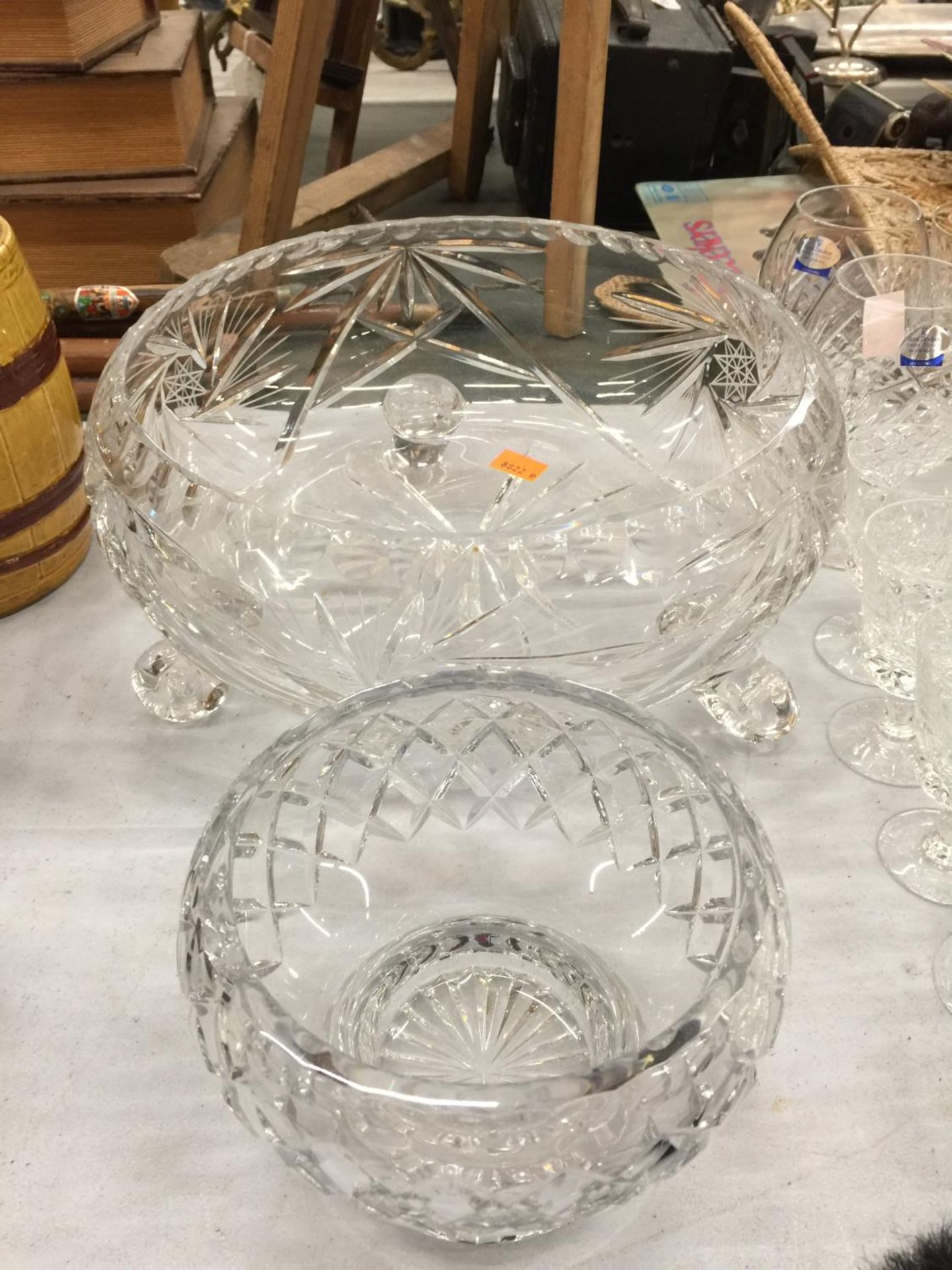 A LARGE CUT GLASS CRYSTAL FOOTED BOWL AND A SMALLER BOWL