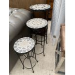 A SET OF THREE GRADUATED TILED TOP TABLES ON METALWARE FRAMES
