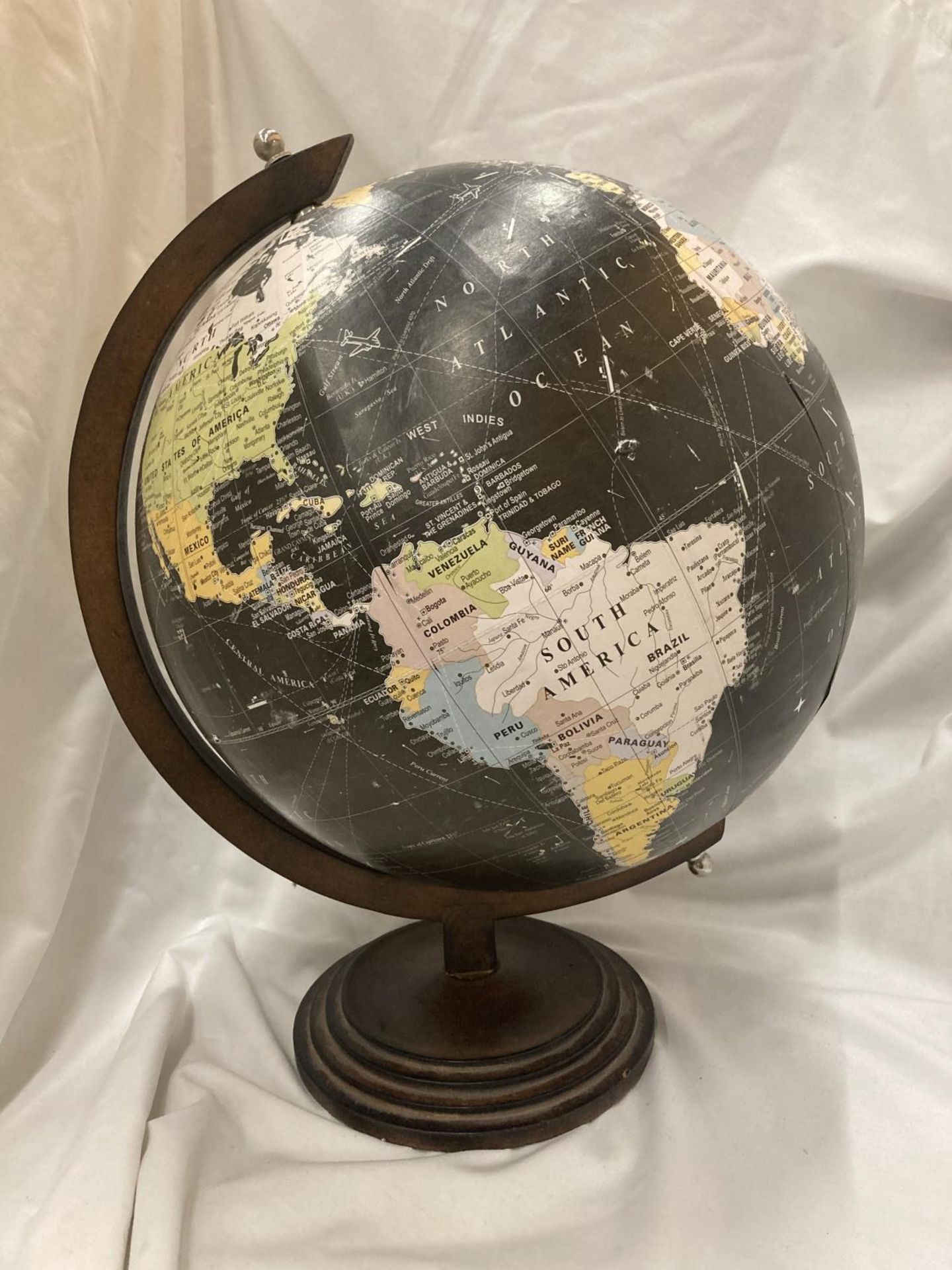 A VINTAGE STYLE GLOBE ON A WOODEN BASE