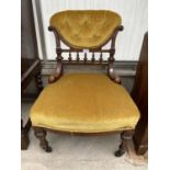 A VICTORIAN WALNUT LOW NURSING CHAIR ON TURNED AND FLUTED FRONT LEGS