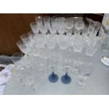 A LARGE ASSORTMENT OF GLASSES TO INCLUDE SHERRY, WINE AND CHAMPAGNE ETC