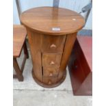 A 17" DIAMETER HARDWOOD CHEST OF THREE DRAWERS