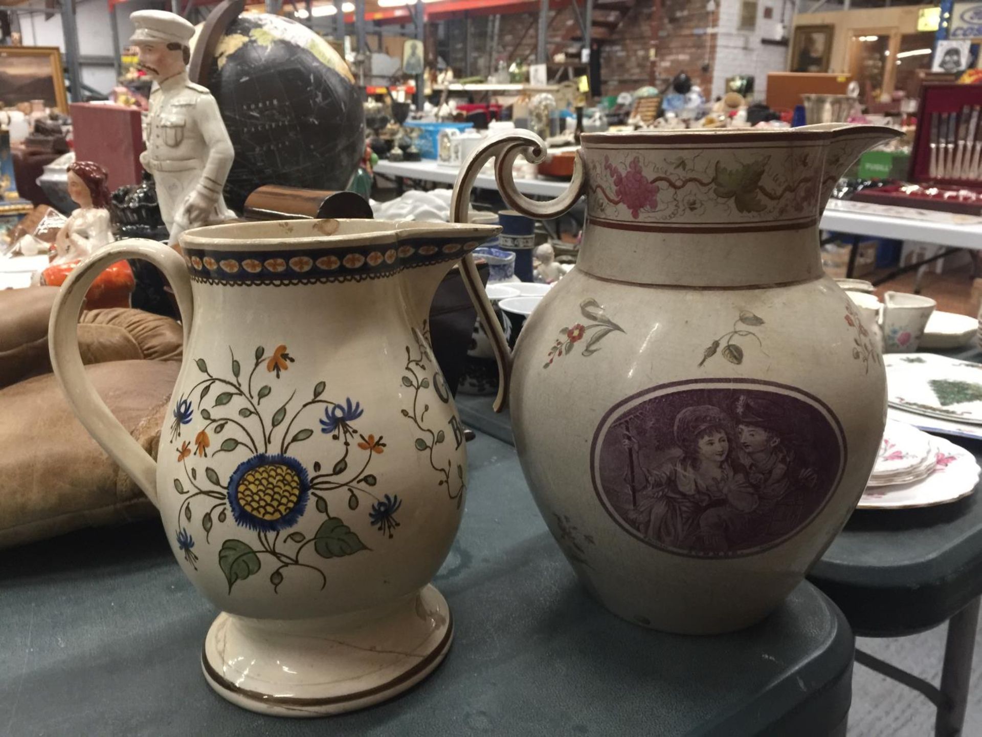TWO VINTAGE JUGS, ONE 'GEORGE BUTLER' - A/F, THE OTHER A LARGE VICTORIAN TRANSFER PRINTED - A/F