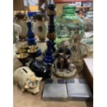 A MIXED LOT TO INCLUDE FIGURINES, CANDLESTICKS, PIGGY BANKS, ETC