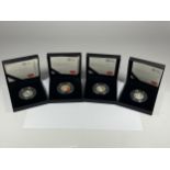 A SET OF FOUR BOXED ROYAL MINT BEATRIX POTTER SILVER 50P PROOF COINS