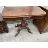 A 19TH CENTURY MAHOGANY FOLD-OVER CARD TABLE ON QUATREFOIL BASE WITH BRASS LION PAW FEET, 35" WIDE