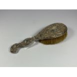 A STERLING SILVER BACKED DRESSING TABLE BRUSH